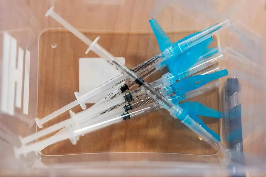 Several syringes with blue caps for brow lift and gummy smile botox